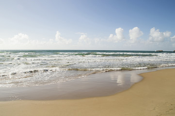 Fototapeta na wymiar Empty sand beach on the ocean or the sea with light waves