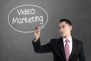 Business man writing video marketing