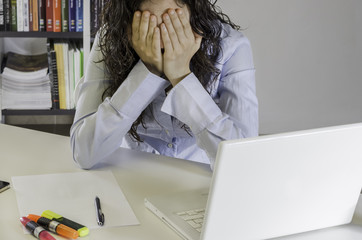 Businesswoman closed face with her hands, office.