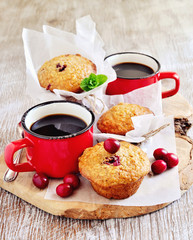 Oatmeal muffins with fresh cranberries, and a mug of coffee for breakfast. Selective focus