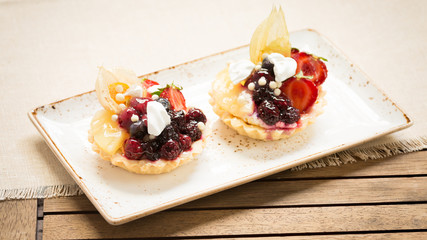 Fruit tarts on a wooden background