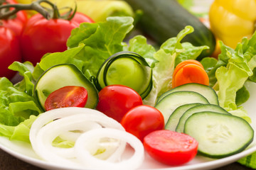 Healthy salad with lettuce, cucumber, cherry tomatoes and onions