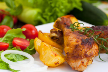 Chicken drumsticks with roasted potatoes and vegetables