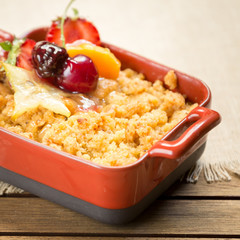 Apple crumble on a wooden background