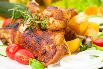 Roasted chicken legs with vegetables and herbs