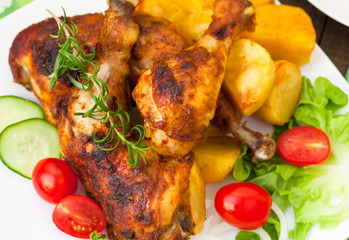 Grilled chicken legs with potatoes and vegetables