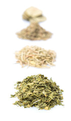 Piles of herbs variety of rosemary, parsley, bay leaves and thyme 