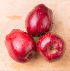 Red apple over wooden background