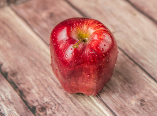 Red apples on weathered wooden background