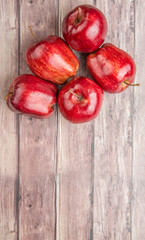 Red apples on weathered wooden background