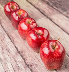 Red apples on weathered wooden background
