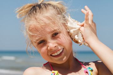 Little girl having fun on a beach