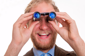 Bearded joyful man watching through binoculars
