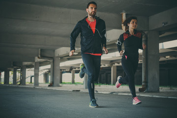 Couple running in an urban environment
