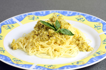 served pasta, spaghetti with cream sauce and zucchini on the plate
