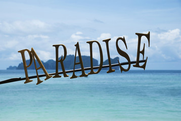 Paradise sign with a sea and islands on background.