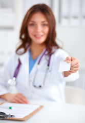 Female doctor holding an empty card, isolated on white