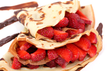 served dessert: isolated pancakes with strawberry and chocolate
