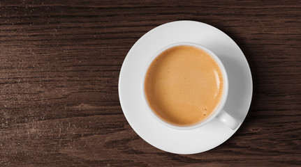 coffee cup and saucer top view on wooden background