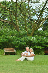 Elderly couple  in tropical garden