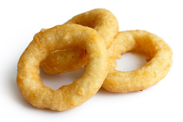 Three deep fried onion or calamari rings isolated on white.
