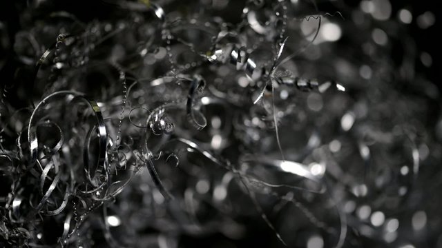 Textured metal shaving scrap background with moving light 