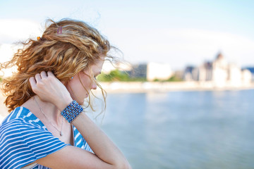 Sad redhead woman on bridge