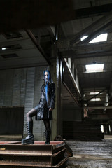 Gothic girl in the image of an abandoned factory