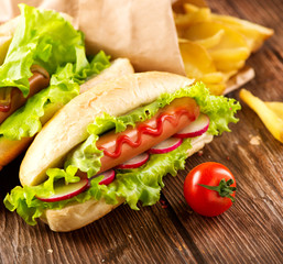 Grilled hot dogs with mustard and ketchup on a wooden table