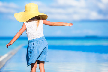 Adorable little girl at beach during summer vacation