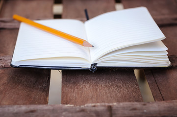 notepad with pen on wood table