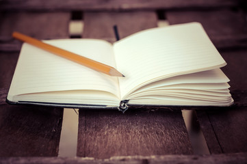 notepad with pen on wood table
