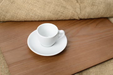 Fototapeta na wymiar white espresso cup on a wooden plate