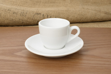 white espresso cup on a wooden plate