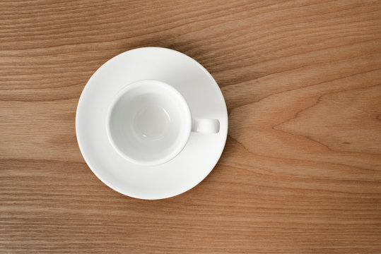 white espresso cup on a wooden plate
