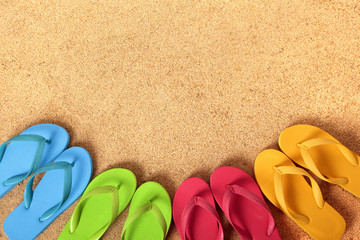 Row line semi circle border of flip flops flipflop summer beach sandals on a sand background team teamwork vacation holiday photo