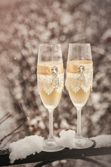 Two glasses with champagne  on the snow