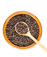 black pepper on wooden spoon with wooden plate isolated on white background.