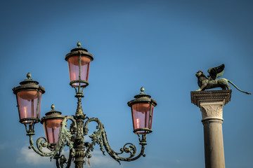 Fototapeta na wymiar Lamppost in Venice with the Saint Mark's lion in the background