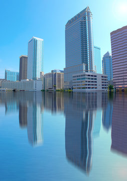 Flooded city with high water and the buildings reflecting in the water.