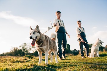 Twins take a walk with the dogs Huskies