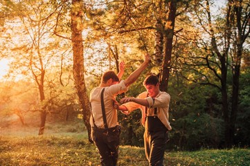 Twin brothers swinging on swing