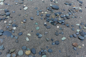 Fototapeta na wymiar Different gray stones pebble beach