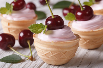 mini tartlets with pink cream and cherries. closeup horizontal
