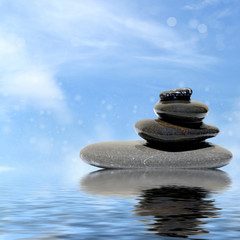 Zen spa concept background - Zen massage stones reflected in water