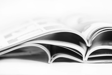a pile of magazines close up on white background