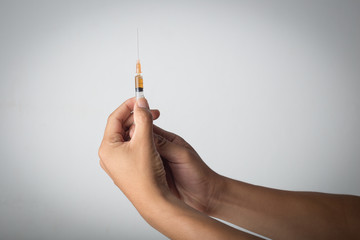 hand holding hypodermic needle