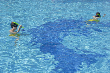 The boys are swimming