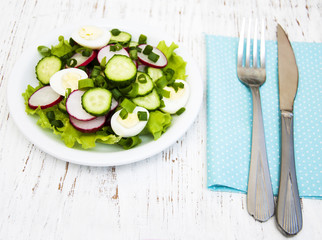 Spring salad with eggs, cucumbers and radish