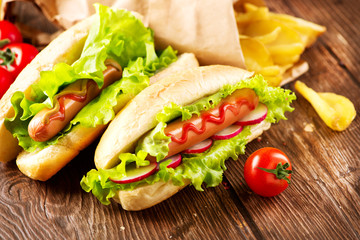 Grilled hot dogs with mustard and ketchup on a wooden table